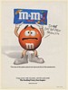 1999 M&M's Crispy Do Not Eat This New Product Orange M&M Holding Bag Print Ad